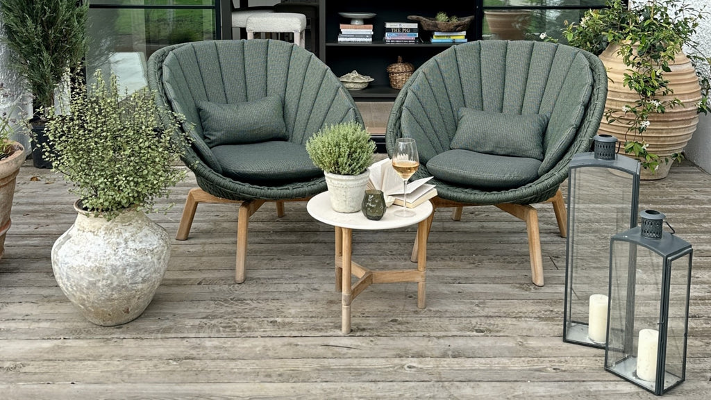 Outdoor dark green lounge chairs with teak legs, shell shaped lounge chair, modern side table with teak base and white ceramic table top