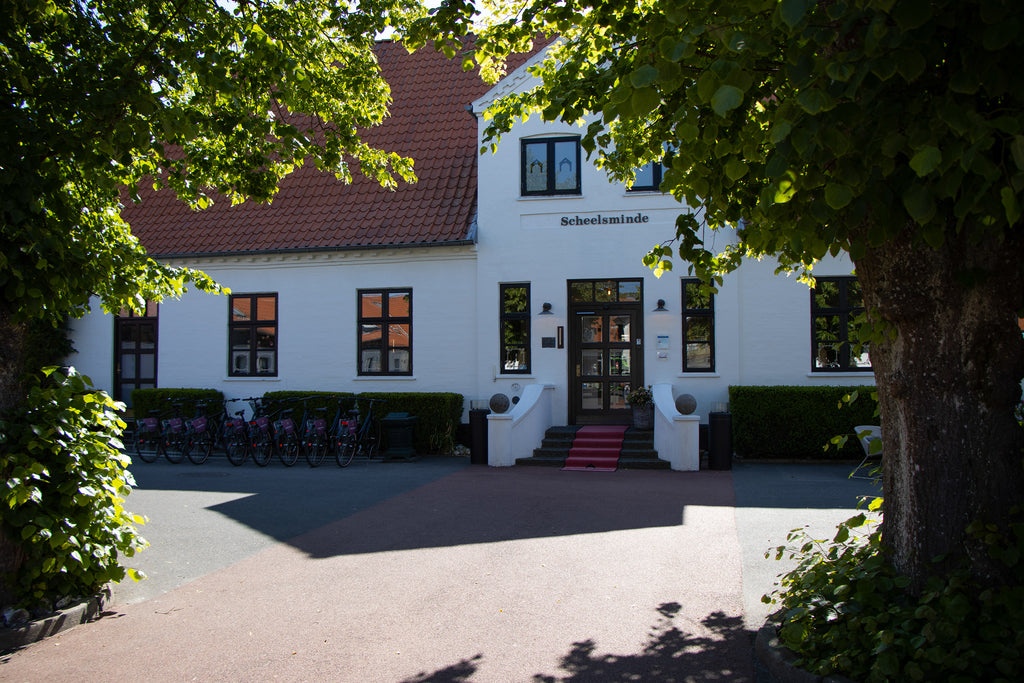 White historical modernized manor at Hotel Scheelsminde, Denmark
