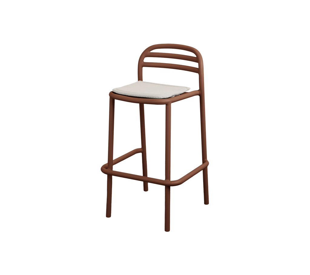 Modern bar stool with desert red frame and sand cushion.