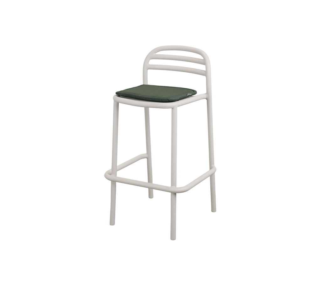 Modern bar stool with a light green cushion.