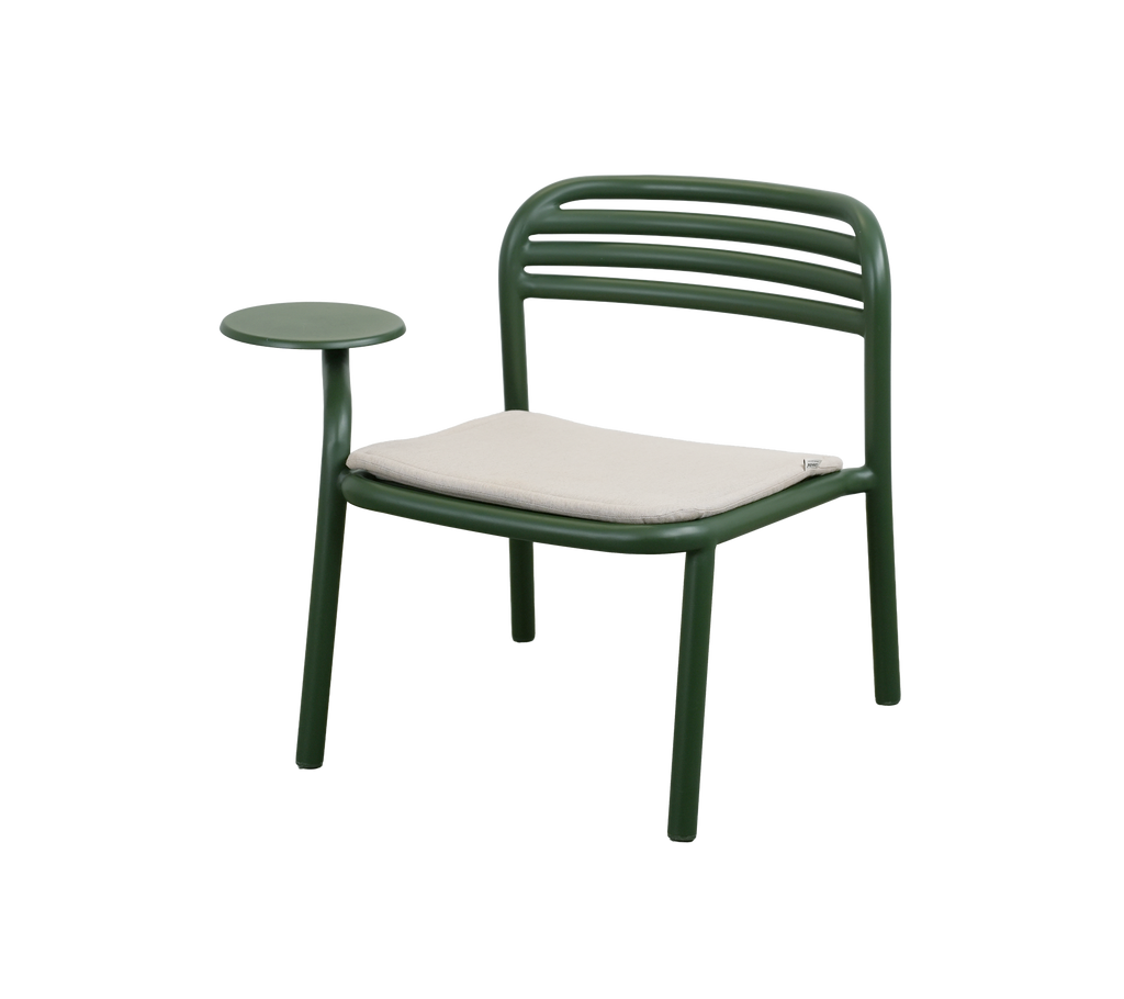 Dark green chair with a sand cushion and side table.