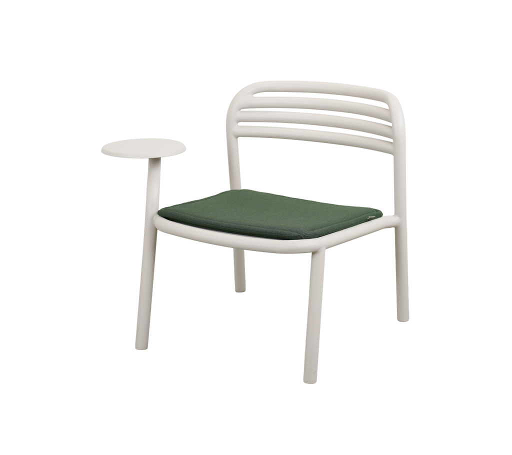Modern chair with light green cushion and side table.
