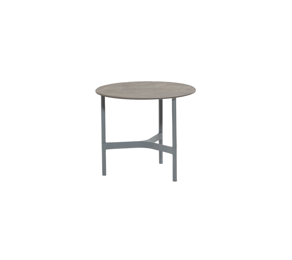 Round light grey table with a minimalist design.