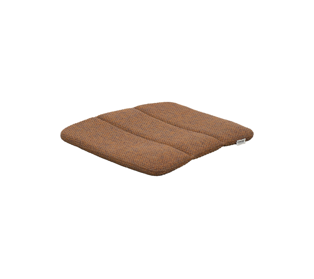 Umber brown cushion with a textured surface.