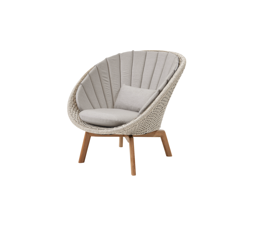 Modern sand chair with a teak cushion in a lounge setting.