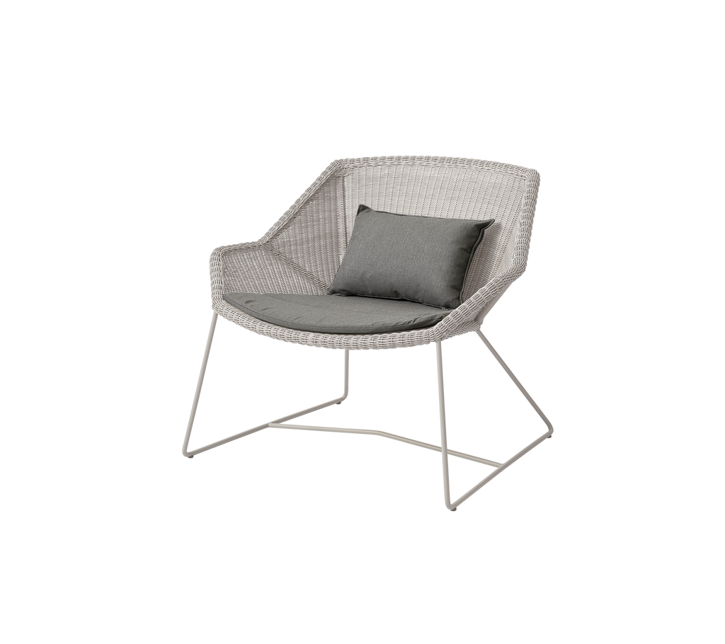 Modern sand-colored chair with a grey cushion.