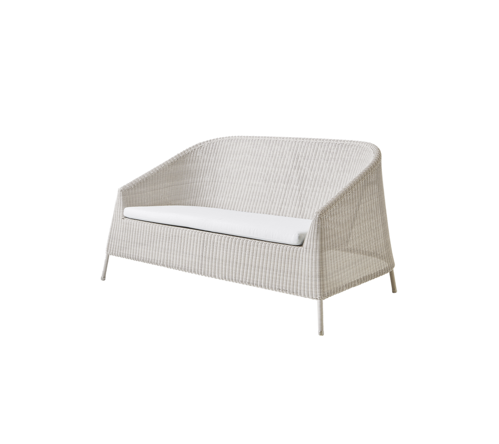 Modern sand loveseat with a white cushion in a minimalist design.