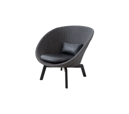 Stylish, rounded armchair with a textured exterior and a sleek leather cushion, perfect for modern decor.