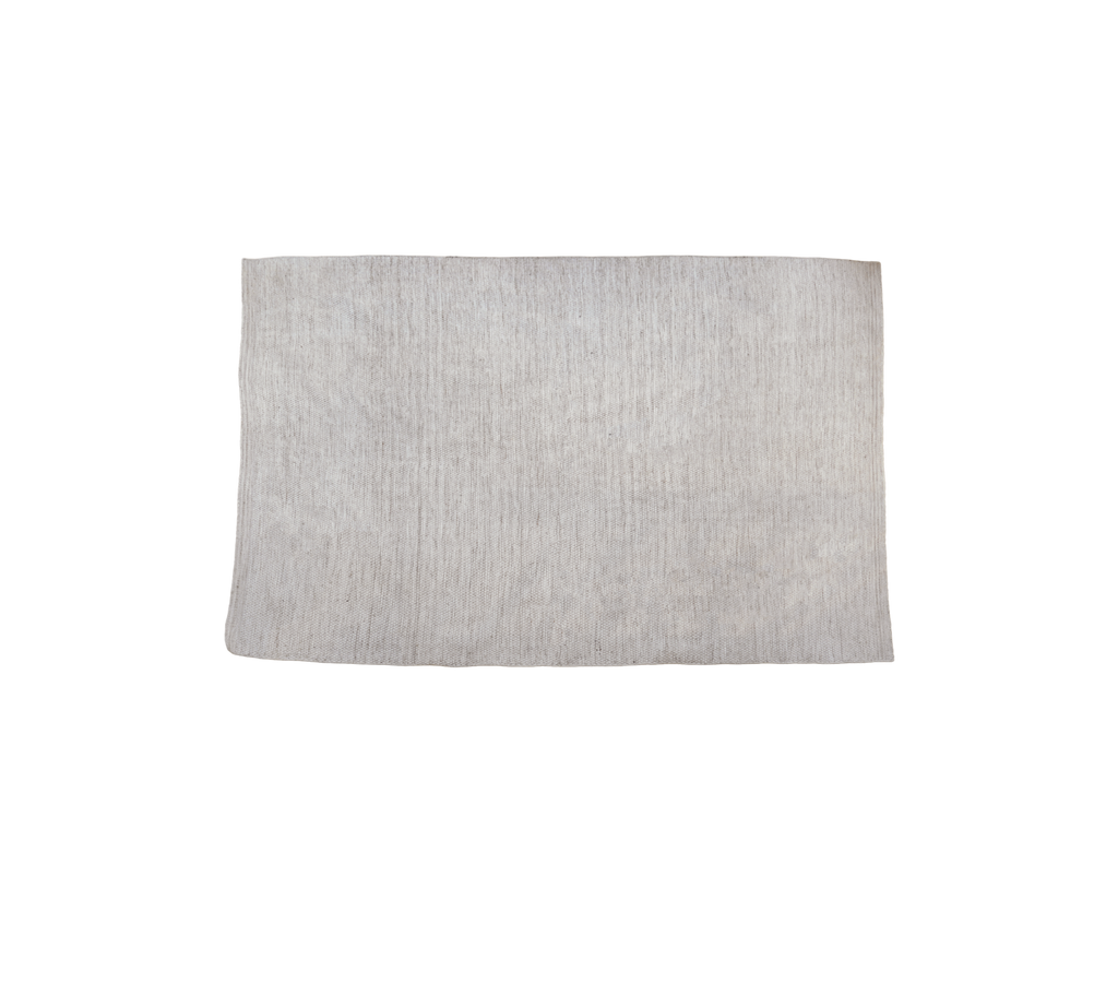 Multi-colour rug in a sand tone with textured surface.