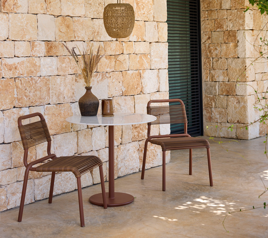 Modern lounge setup featuring brown chairs and a white table.