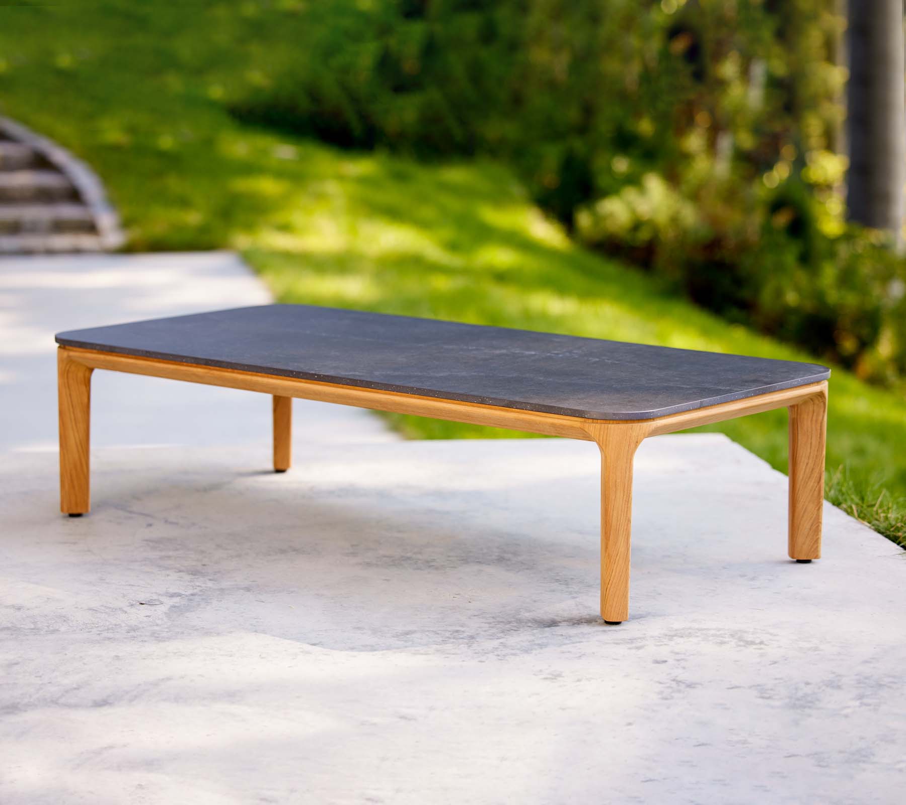 A sleek coffee table with a dark surface and light wooden legs, ideal for modern living spaces.