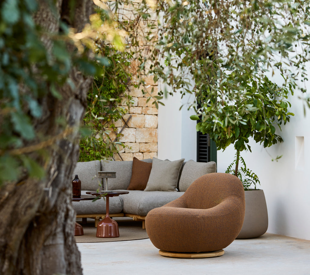 Modern lounge area featuring a brown chair and grey sectional sofa.