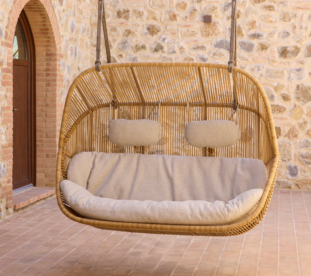 Hanging Hive sofa with plush rise cushions, featuring a natural woven design and a cozy seating area. Perfect for relaxation.