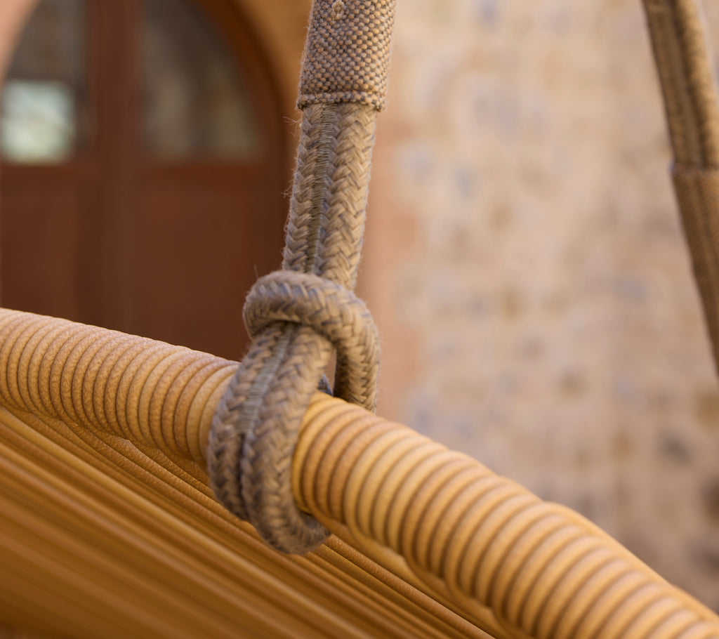 Close-up of a rope knot on a modern Hive sofa, showcasing its woven texture and design details.