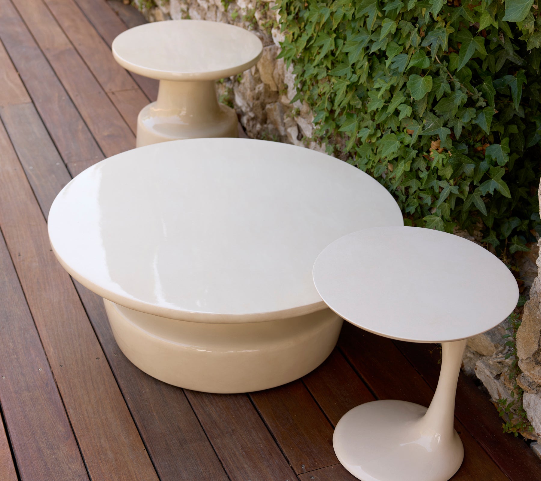 Modern white coffee table and side table in a lounge setting.