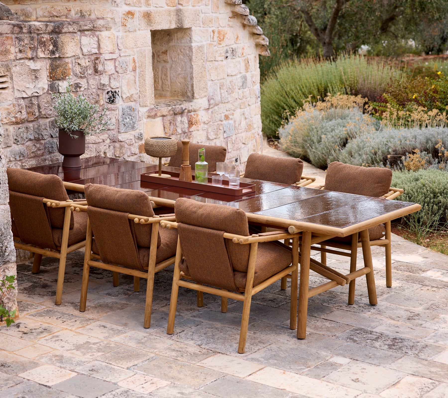 Modern outdoor dining set with brown chairs and a matching table.